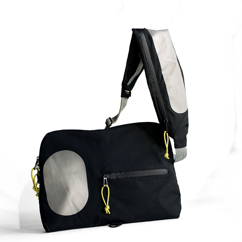 2-i-1 taske med refleks strap der kan bruges som crossbody og øger synlighed i trafikken