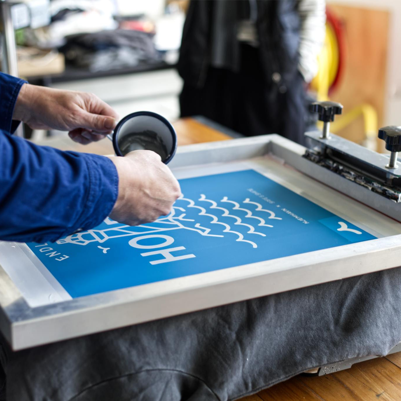 Produktion af HOPE hoodie med refleksprint under serigrafisk tryk hos dansk tekstiltrykkeri
