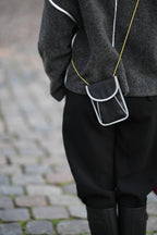 A person goes out on the town with a reflective bag strap for everyday use