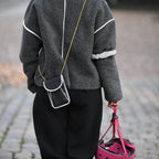 A person goes out on the town with a reflective bag strap for everyday use
