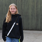 child with a reflective strap that increases visibility in everyday traffic