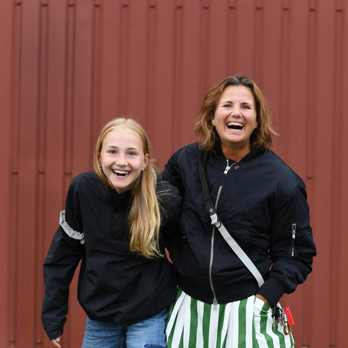 A mother and child wearing reflective gear to improve visibility in everyday traffic
