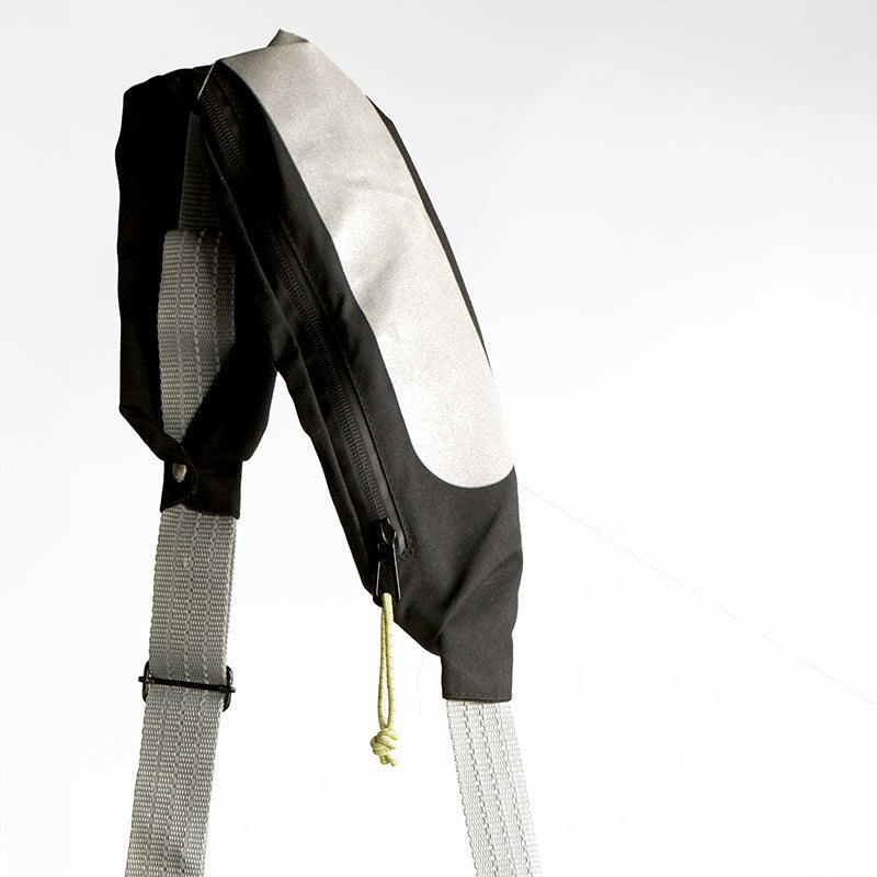 2-i-1 taske med refleks strap der kan bruges som crossbody og øger synlighed i trafikken