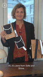 Video in which Safe and Shine presents a reflective bag and reflective strap for increased visibility in traffic